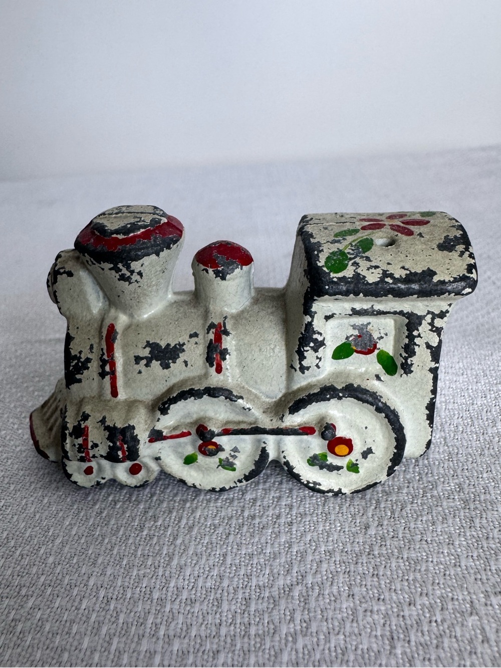 Antique cast iron salt or pepper shaker w hand-painted folk art designs